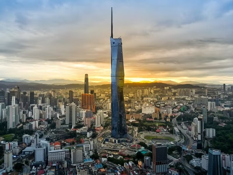Merdeka 118 rising above the Kuala Lumpur skyline at sunset